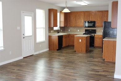 Kitchen with a sink, decorative backsplash, a kit