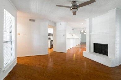 Gleaming wood floors flow through the living room,