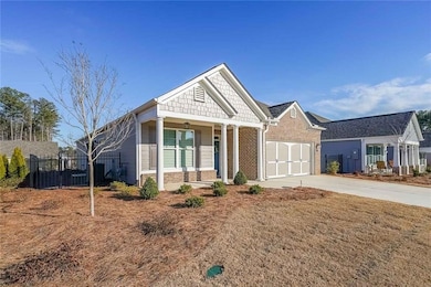 Craftsman-style house with brick siding, driveway,