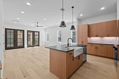 Kitchen featuring an island with sink, tasteful b