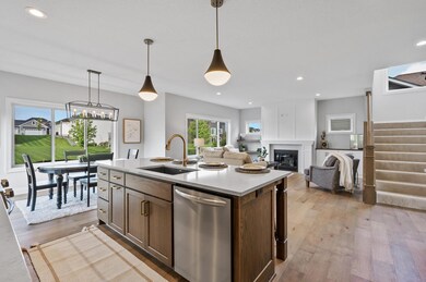 Adorned with quartz Cashmere Taj countertops, both the kitchen and all bathrooms exude luxury and refinement.