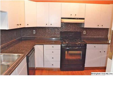 Updated kitchen with glass block backsplash.