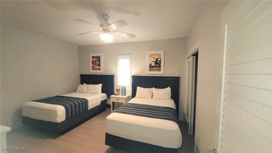 Bedroom featuring a closet, ceiling fan, and wood