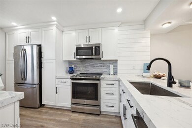 Kitchen with stainless steel appliances, light sto