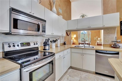 Kitchen featuring light countertops, white cabinet