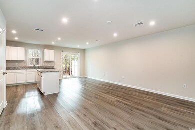 Kitchen with visible vents, white cabinets, open f