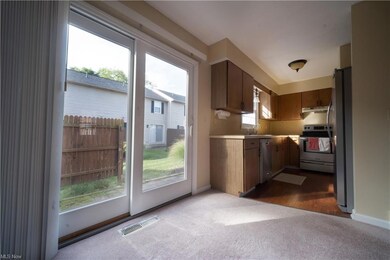 Dining Area to Galley Kitchen & Sliding Door to Patio