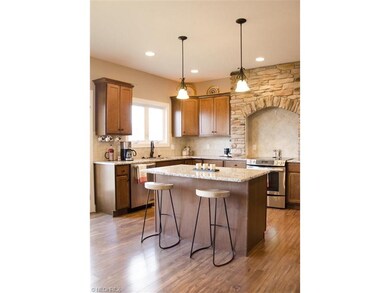 The pendant lights and recessed lighting creates a