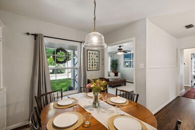 Dining room with ceiling fan and dark wood-type fl