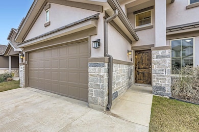 Doorway to property with stucco siding, stone sid