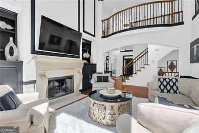 Living area featuring arched walkways, a fireplace