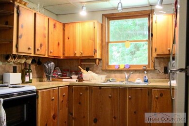 Kitchen: Wood cabinetry in the kitchen enhances the mountain feel of this quaint cabin.