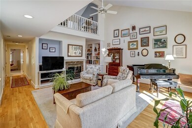 Hardwood floored living room featuring vaulted cei