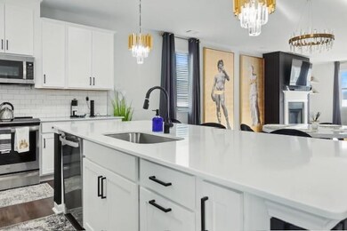 Kitchen with an inviting chandelier, a sink, light