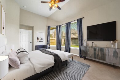 Come and unwind after a long day in this magnificent master suite! This spacious room features plush carpet, custom paint, high ceilings, dark stained ceiling fan with lighting, and large windows with privacy blinds.
