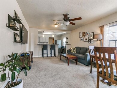 Carpeted living room with ceiling fan and lots of 