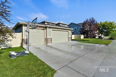 View of side of home featuring concrete driveway and a garage