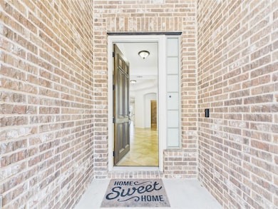 Doorway to property featuring brick siding