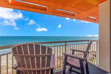 Balcony with a water view and a view of the beach