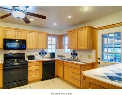 Kitchen. Ceramic tile counter tops and lots of cab