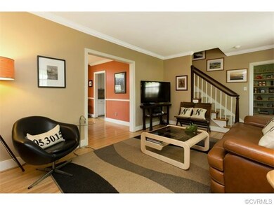 Living room with view to dining room and staircase