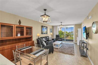 Living room featuring a chandelier, light tile patterned flooring, and baseboards