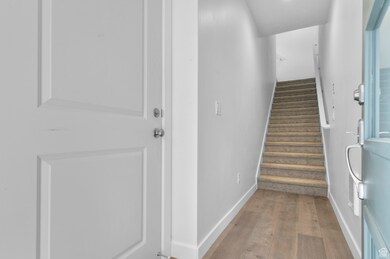 Entryway with dark wood-style flooring and stairs