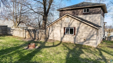 Back of house with roof with shingles