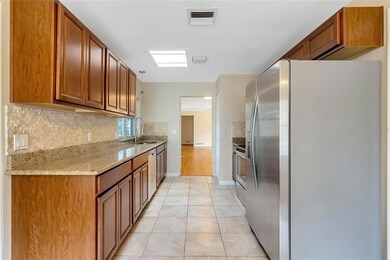 Kitchen with granite counters and stainless appliances 
