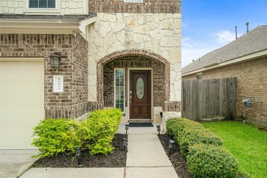 Front door with stone and brick arch way for the entrance.