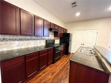 Kitchen featuring under cabinet range hood, visibl