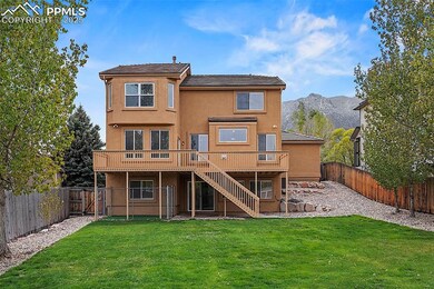 Rear view of property featuring stairs, a deck wit