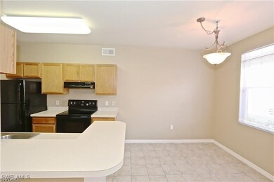 Kitchen featuring baseboards, light countertops, l