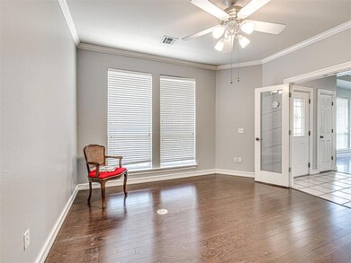 Living area with crown molding, dark tile flooring