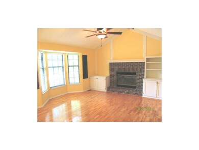 Beautiful hardwoods, ceiling fan and bay windows.