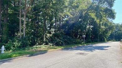 View of asphalt road featuring curbs