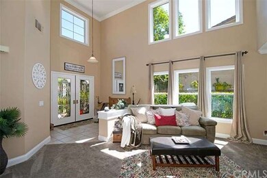 Open, airy, and bright living room has two story c