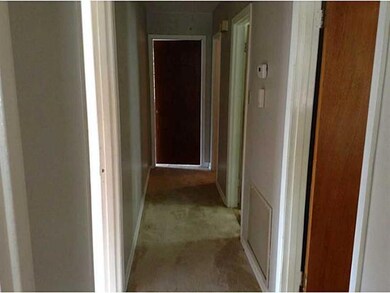 Photo. Hallway leading to bedrooms and baths.