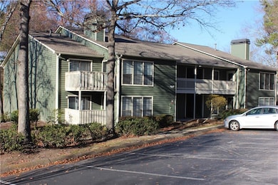 View of building exterior featuring uncovered parking