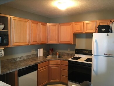 open kitchen with stove, refrigerator, dishwasher 