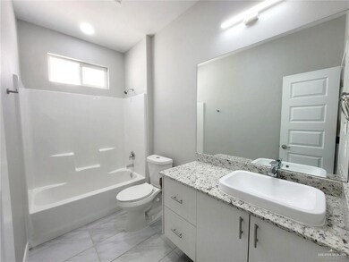 Bathroom featuring marble finish floor, toilet, vanity, and bathing tub / shower combination