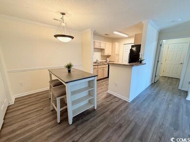 Kitchen with sink, white cabinetry, black refriger