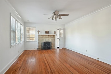Unfurnished living room featuring ornamental moldi