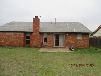 Back yard has wood fence, open patio, and sliding 