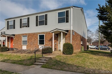 View of front of home with a front lawn and brick
