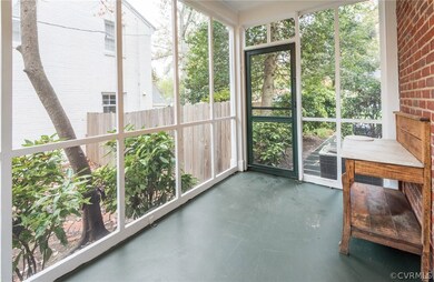 Side screened porch with brand new screens and a freshly painted floor.