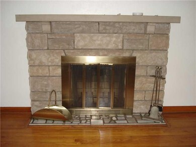 Living Room. Stone fireplace w/beautiful hardwood 