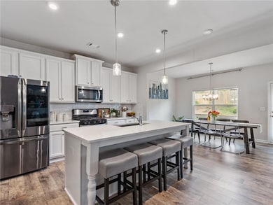 Kitchen featuring stainless steel appliances, a si