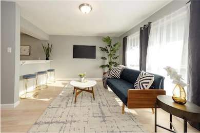 Living area featuring baseboards and wood finishe