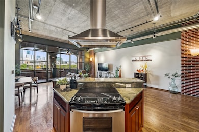 Island has oven and cooktop overlooking the living